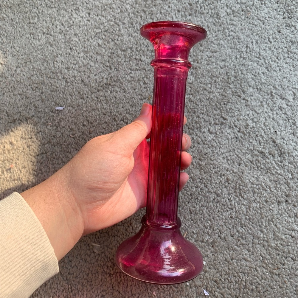 Vintage magenta pillar shaped glass candlestick holder